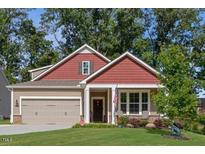 Charming two-story home with a well-manicured lawn and attached two car garage at 100 Pronghorn Deer Ct, Garner, NC 27529