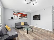 Inviting living room with modern decor, wood flooring, and stylish furnishings at 1002 Willow Dr # Apt 107, Chapel Hill, NC 27514