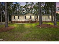 Charming home with a manicured lawn and surrounded by mature trees at 101 Hunter Fld, Sanford, NC 27332