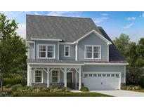 Charming two-story home featuring a covered front porch and an attached two-car garage at 1017 Dillon Lake Dr, Knightdale, NC 27545