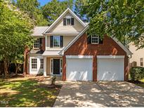 Charming two-story home features a two-car garage, brick accents, and a well-manicured lawn at 103 Burham Ct, Apex, NC 27502