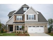 Charming two-story home featuring a brick facade, dark shutters, and a spacious two-car garage at 1042 Tulloch Court Ct # 213, Burlington, NC 27215
