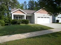 Charming single-story home featuring a well-maintained lawn and an attached two-car garage at 126 Kipling Dr, Oxford, NC 27565