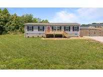 Charming home featuring a welcoming front porch and well-maintained lawn at 130 Ruby Trl, Roxboro, NC 27574
