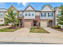 Charming townhome with well-maintained landscaping, brick accents, and inviting curb appeal at 136 Thornhill Dr, Burlington, NC 27215