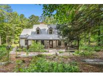 Charming home with a cozy front porch surrounded by lush greenery and trees, offering a peaceful retreat at 139 Trillium Pl, Chapel Hill, NC 27517