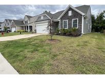 Charming home featuring stone accents, well-maintained landscaping, and an attached two-car garage at 146 Verona Villa Dr, Burlington, NC 27215