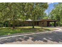 Modern stone home with a porte-cochere and mature trees providing shade at 1846 Hammond St, Rocky Mount, NC 27803