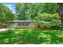 Charming brick home with a well-maintained lawn and lush greenery, offering great curb appeal at 202 Howland Ave, Cary, NC 27513