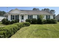 Charming one-story home with green shutters and a well-maintained, lush front yard at 224 Clearwater Dr, Smithfield, NC 27577