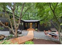 Charming home exterior showcasing a walkway, outdoor seating, and lush landscaping, inviting relaxation and outdoor living at 2306 Damascus Church Rd, Chapel Hill, NC 27516