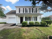 Charming two-story home featuring a covered front porch, attached garage, and well-maintained landscaping at 308 Quartz Dr, Durham, NC 27703