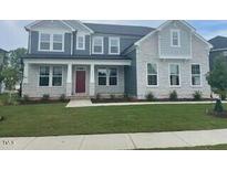 Beautiful two-story home with a well-manicured lawn and a welcoming front entrance at 3521 Bailey Lake Dr, Fuquay Varina, NC 27526