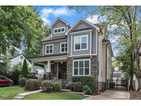 Charming two-story home featuring gray siding, stone accents, and a welcoming front porch at 425 Morrison Ave, Raleigh, NC 27608
