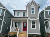 Charming two-story home with a red door and a welcoming front porch at 508 Yeowell Dr, Chapel Hill, NC 27514