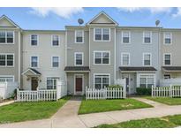 Charming townhome featuring a well-maintained front lawn and inviting entrance at 8620 Neuse Club Ln # 107, Raleigh, NC 27616