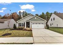 Charming single-story home featuring a two-car garage, manicured lawn, and inviting covered entrance at 105 Old Arcadia Lane Way, Youngsville, NC 27596