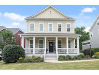 Charming two-story home with a welcoming front porch and well-maintained landscaping at 113 Market Cross Ct, Holly Springs, NC 27540