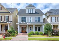 Charming two-story home with a cozy front porch, beautiful door and manicured landscaping at 1217 Chalk Maple Dr, Cary, NC 27519