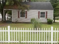 Charming home featuring red shutters and a quaint white picket fence at 1256 Planters St, Rocky Mount, NC 27801
