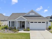 Charming single-story home featuring a two-car garage, manicured lawn, and a welcoming entrance at 1727 Pinecliff Ct, Fuquay Varina, NC 27526