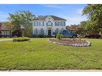 Charming two-story house with blue shutters, manicured lawn, and decorative landscaping at 3013 Brassfield Dr, Rocky Mount, NC 27803