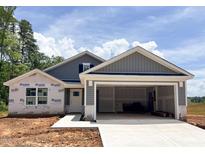 New construction home featuring vertical siding, covered entrance and an attached two-car garage at 318 Rothbury Ct, Sanford, NC 27330