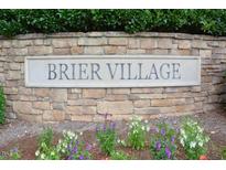 Stone monument sign in a flower bed displaying the community's name, Brier Village at 321 Westgrove Ct, Durham, NC 27703