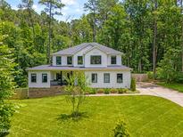 Beautiful two-story home features a manicured lawn, and professional landscaping at 322 Scheer Ave, Durham, NC 27703