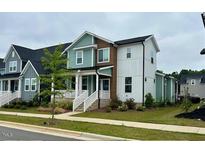 Charming two-story home with a combination of blue, brown, and white siding at 34 Millennium Dr, Pittsboro, NC 27312