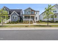 Charming two-story home with a covered front porch and well-manicured lawn at 34 Millennium Dr, Pittsboro, NC 27312