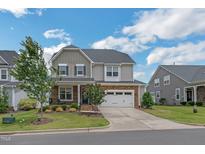 Charming two-story home with a two-car garage and a beautifully landscaped front yard at 40 Two Creeks Loop, Chapel Hill, NC 27517