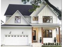 Beautiful modern farmhouse exterior with white siding, black trim, and a welcoming front porch at 4035 King Charles Rd, Durham, NC 27707