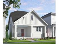 Charming exterior of a cottage-style home with a red front door and inviting front porch at 528 Folk Song Way, Wendell, NC 27591