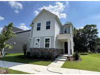 Charming two-story home with a stone facade and well-manicured lawn at 5649 Cayden Cove Dr, Wendell, NC 27591