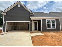 New construction home showcasing a two-car garage and stylish gray siding under a cloudy sky at 798 Old Station Pointe, Angier, NC 27501