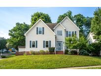 Charming two-story home with blue shutters and manicured lawn at 8701 Erinsbrook Dr, Raleigh, NC 27617