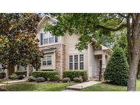 Charming two-story townhouse with stone accents, manicured landscaping, and welcoming front entrance at 100 Tobacco Leaf Ln, Apex, NC 27502