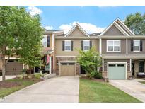Charming townhome featuring a driveway and attached garage nestled in a well-maintained neighborhood at 103 Ransomwood Dr, Apex, NC 27539