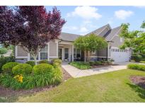 Charming single-Gathering home with well-manicured landscaping and inviting front porch with stone accents and a two car garage at 1120 Hooper Pl, Durham, NC 27703
