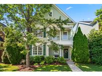 Charming two-story home boasts a covered porch, lush landscaping, and a welcoming entrance at 1201 Somers Dr, Morrisville, NC 27560