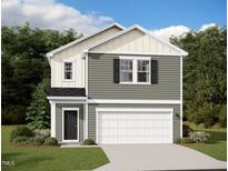 Charming two-story home with a two-car garage, black door, and classic architectural details at 1212 Solace Way, Rolesville, NC 27571