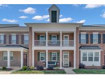 Charming brick townhome with a covered front porch and upper balcony at 1312 Regulator St, Raleigh, NC 27603