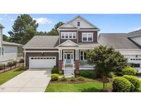 Charming two-story home with a well-manicured lawn and a welcoming front porch at 1508 Heritage Reserve Ct, Wake Forest, NC 27587