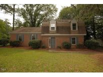 Charming brick home with manicured lawn, mature trees, and inviting curb appeal at 1513 Western Ave, Rocky Mount, NC 27804