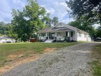 Charming one-story home with a covered front porch and a gravel driveway at 2037 Swepsonville Rd, Graham, NC 27253