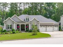 Charming single-Gathering home features a landscaped front yard and three-car garage at 2121 Vecchio Ln, Apex, NC 27502