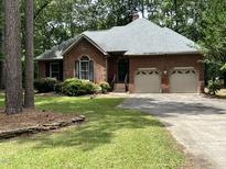 Charming brick home featuring a two-car garage and well-maintained front yard at 2237 Keith Hills Rd, Lillington, NC 27546