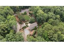 Beautiful home with manicured lawn surrounded by lush trees providing a private, estate-like setting at 2283 Mays Chapel Rd, Sanford, NC 27330