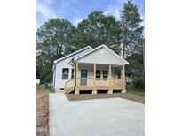 Charming single-story home with a welcoming front porch and a newly paved driveway at 2301 Pinecroft Dr, Burlington, NC 27217